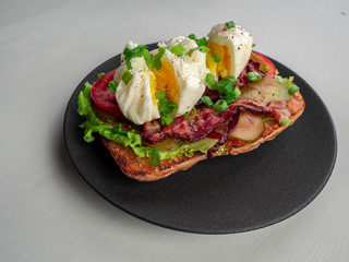 Toast with bacon, tomato ,pickle and boiled eggs