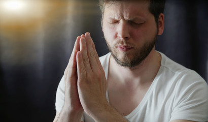 Naklejka premium man praying close up portrait