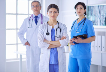 Fototapeta premium Group of doctors and nurses standing in a hospital room