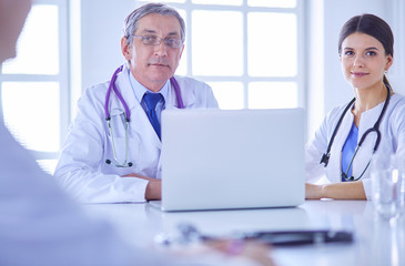 Serious medical team working in a bright office