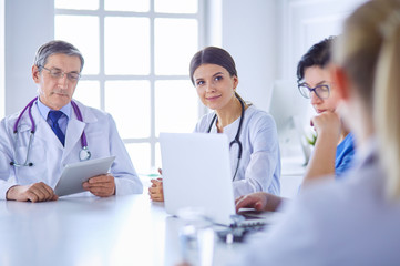 Doctors consulting with each other in a hospital conference room