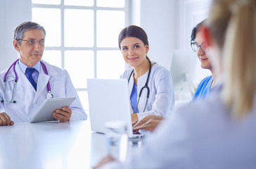 Doctors consulting with each other in a hospital conference room