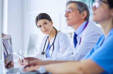 Doctors consulting with each other in a hospital conference room