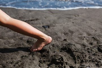 Blonde girl plays happy on the beach