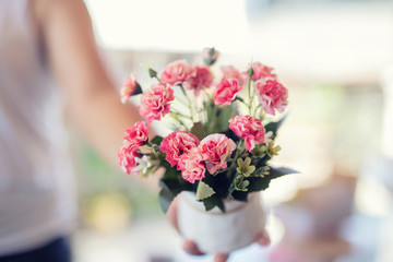 Holding a vase in hand