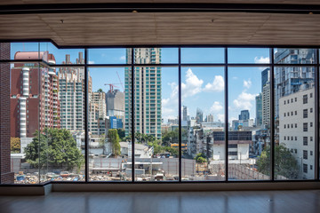 Business district and clouds blue sky view from big glass windows in commercial building