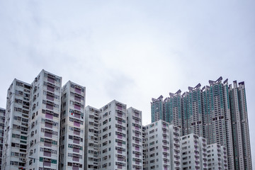 Complex of condominium buildings in residential district with overcast sky background and copy space