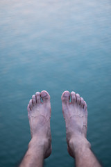 top view of a man's foot on river. selective focus.