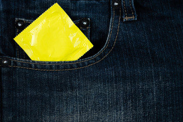 condom on jeans pocket (World AIDS Day concept), soft focus.