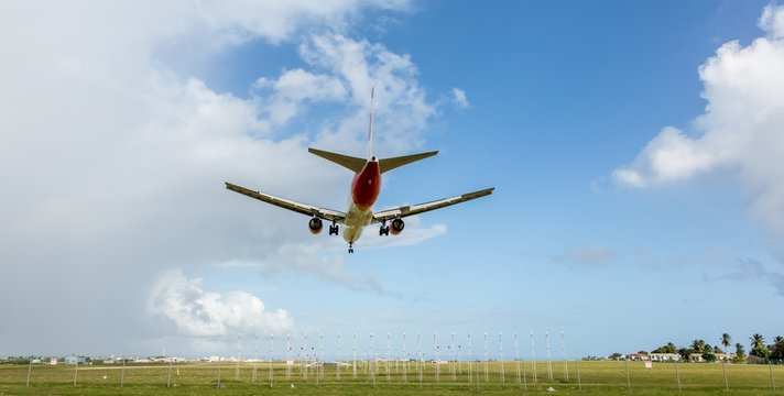 Jet aeroplane descending to land at airport
