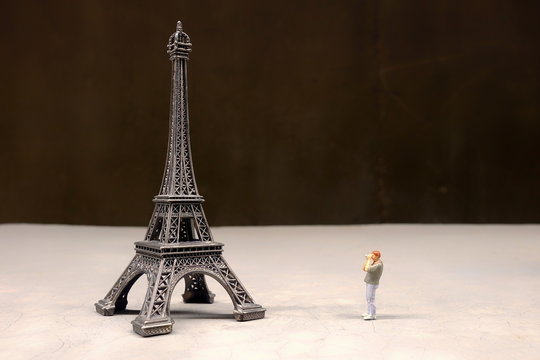 Close up Miniature People, Photographer taking a Photo of Eiffel Tower.