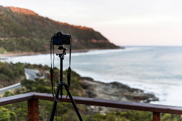 Naklejka premium Tripod & camera placed on top of holiday house decking.