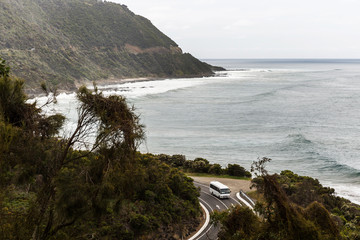 Tourist bus driving along Great Ocean Road, Victoria, Australia.