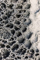 Volcanic seaside rock texture.