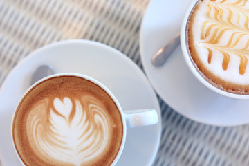 hot caramel macchiato and latte coffee drink put on table in cafe