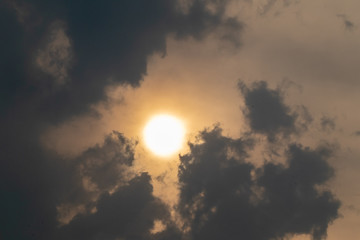 the sun hide behind grey cloud at evening