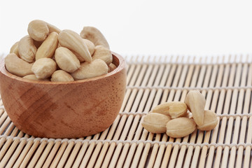 Cashew nuts raw in cup  on wood with a white background
