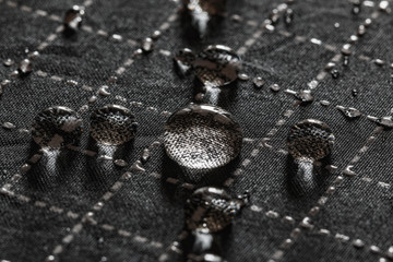 Rain Water droplets on a black waterproof fabric