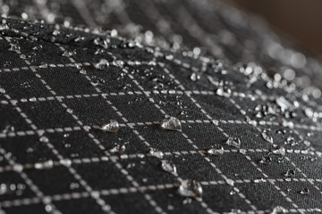 Rain Water droplets on a black waterproof fabric