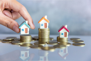 Mini house on the table, Money and house,  Mortgage, Savings money for buy house and loan to...