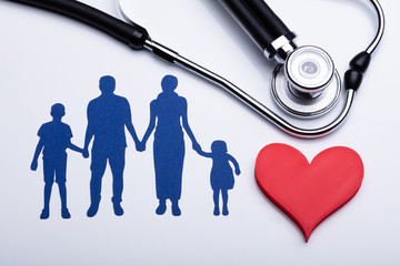 Close-up Of Family Cut Out, Red Heart Shape And Stethoscope