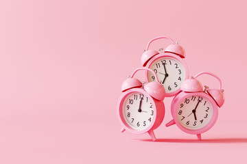 Alarm clock on pastel pink background. minimal concept. 3d rendering
