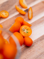Kumquat slices cut on wooden board 