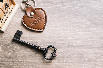 Abstract love. Brow heart and metal key and wooden calendar on wooden table and copy space used for...