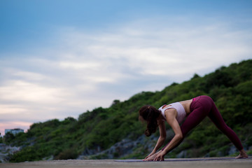 Rear view of healthy women practicing yoga. warm up yoga pose,   .beautiful landscape view sky on...