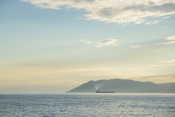 Obraz na płótnie Canvas tanker at sunset seascape at Novorossiysk city, Black Sea coast bay, Russia stock photo image