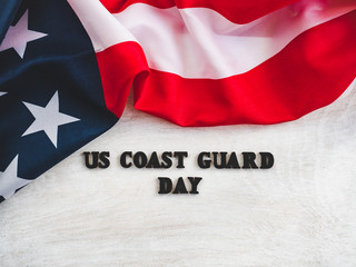 Beautiful card for US Coast Guard Day. Wooden letters with a congratulatory inscription on a white background. Close-up, top view. Congratulations for loved ones, relatives, friends and colleagues