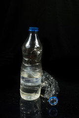 Plastic water bottle isolated on black background
