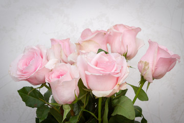 A beautiful bouquet of fresh pink roses in an expensive vase