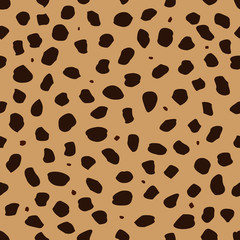Cheetah skin with stains as a seamless pattern, spots are scattered in a chaotic manner, a trendy background for a fabric or a cover on the theme of African animals