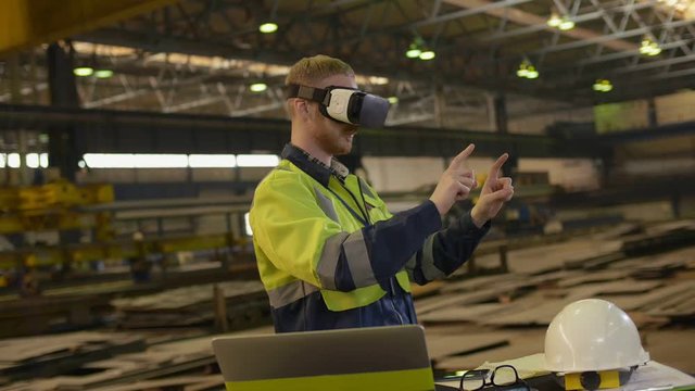 a man wearing 3D glasses gesticulating with his hands