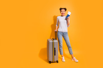 Full length body size portrait of cheerful satisfied student prepared for long trip voyage holding...