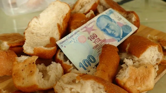 waste of bread and 100 Turkish Lira banknotes, stale bread and material damage, hungry people and bread wastage,