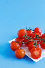 Cherry tomatoes on a blue  background