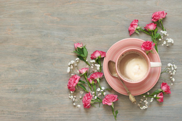 Cup of creamy coffee with flowers decor