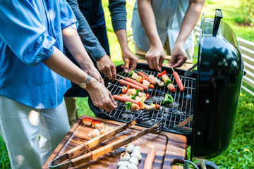 Party group of middle age with bbq grilled and drink