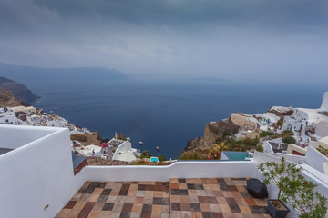 Panorama of the village of Oia and the caldera on a rare rainy day