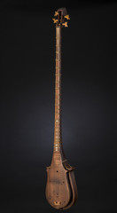 Naklejka premium ancient Asian stringed musical instrument on black background with backlight