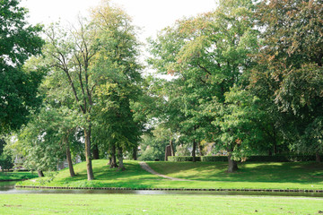 green park with trees, grass, pond in fortified city Elburg, The Netherlands