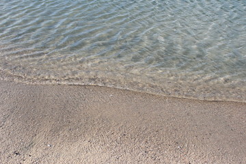 Fototapeta na wymiar Waves washing up on sand