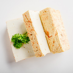 Soy Bean curd tofu with greens on white background Non-dairy alternative substitute for cheese