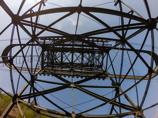 The pylon of the cableway that connects the towns of Albino and Selvino. Green painted pylons to camouflage them in the woods
