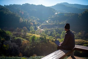 Traveller use laptop in morning , mountain landscape