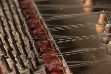 ancient Asian stringed musical instrument on black background with backlight. the similarity of the harp and psaltery. close-up