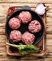 Raw uncooked meatballs