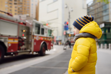 Little boy looks on fire engine. New York, USA.
